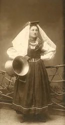 Woman wearing traditional costume and holding copper container, Abruzzo, Italy