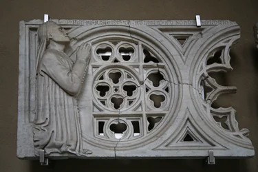 Carved rose wheel transenna with the donor Francesco de Felici