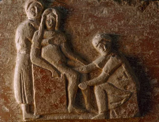 A relief from the tomb of a Roman man and wife shows a woman giving birth. Museo Archeologico.