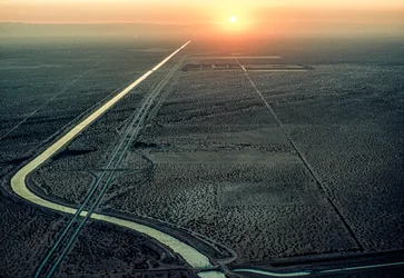 Aerial view of the All-American Canal as the blazing sun sets in the west