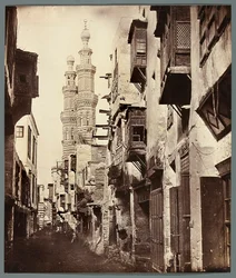 Egypt. Cairo. Alley - in the background, minarets of the Mamluk Mosque of Al-Mu