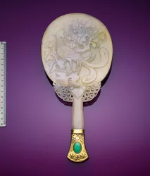 A White Jadeite and Gilt Silver Mirror with a Low Relief of a Phoenix and a Peony