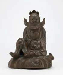 Figure of Shoki, the demon queller, seated on a rock, Edo period or Meiji era