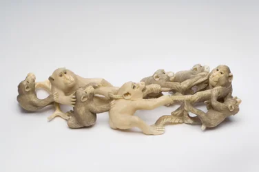 Okimono carved as eight Japanese Macaque monkeys engaged in neck wrestling
