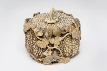 Okimono carved as four playful rats jumping over a pumpkin