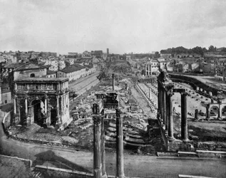 The Forum in Rome with ruins of ancient monuments: Arch of Septimius Severus (l.), columns of the Temple of Saturn (r.) and columns of the Temple of Vespasian (c., foreground)