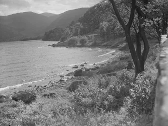 View of lakeshore and hills in background