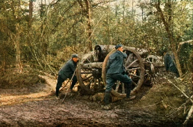 Three French soldiers in the woods with a Howitzer, Verdun, September 1916