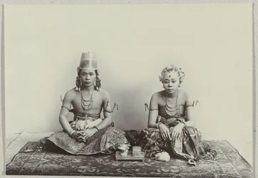 Studio Portrait of a Seated Young Javanese Man and Woman Wearing a Batik Sarong