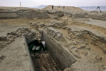 Archaeologist excavates the remains of a woman buried in a wooden coffin next to the Nile, 2005
