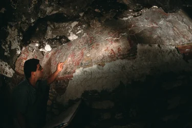 William Saturno inspects mural; San Bartolo; Guatemala; Maya