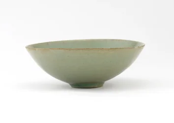 Bowl with molded design of fish among waves