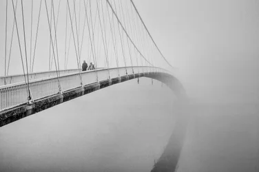 People on a Misty Bridge