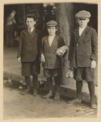 Three Boys on City Street in Knickers and Caps