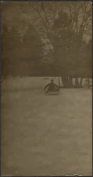 Figure on Sled in Snow
