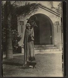 Florence in Costume with Plant Outside House
