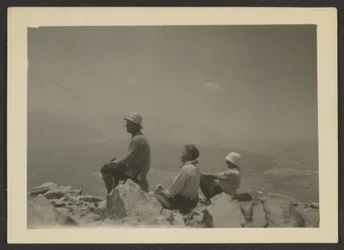 Hikers Seated on Rocks
