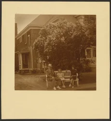 [Man and Young Girls on Bench Before House]