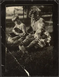 Man with Children and Puppies in Yard