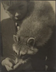 Portrait of a Boy Feeding a Raccoon