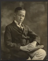 Portrait of a Boy with Cap on Knee