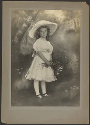 Portrait of a Girl with Flowers before Painted Backdrop