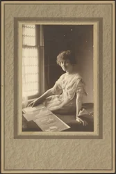 Portrait of a Woman Looking at Album
