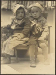 Two Children Sharing Chair