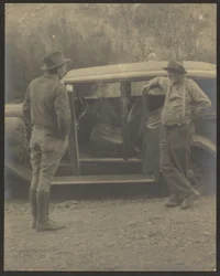 Two Men in Front of a Car