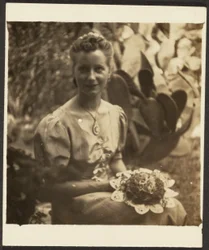 Woman Holding Bouquet Sitting before Cactus