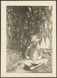 Woman in Costume Sitting in Garden