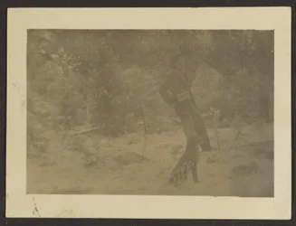 Young Man with Dog in Field