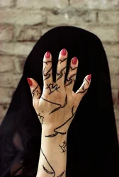 Yemenite woman with her hands decorated with henna dye in North Yemen
