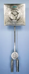 A wall clock by Margaret Gilmour, decorated in repousse with Celtic entrelac designs