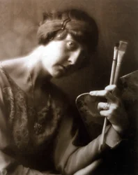 Half-length portrait of the painter Elisabeth Chaplin. She is holding two brushes and a palette in her left hand