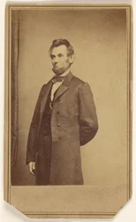 Abraham Lincoln standing with one arm behind his back