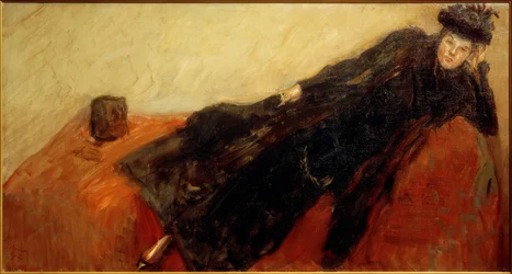 Nini in a Black Dress on a Red Sofa