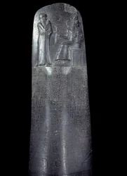 Mesopotamia: stele in diorite of the Code of Laws of Hammurabi. It is covered with cuneiform inscriptions and at the top King Hammurabi stands before the sun god of Mesopotamia, Shamash, divinity of Justice