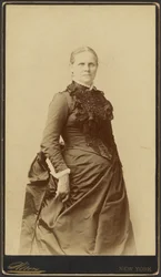 Unidentified woman in long dress standing