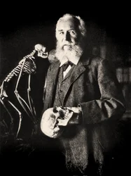 Portrait of Ernst Haeckel next to the skeleton of a monkey, c.1860