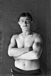 Portrait of a traveling circus wrestler, passing by Andelot Blancheville (Haute Marne). Photograph, circa 1886, by Paul Emile Theodore Ducos (1849-1913).