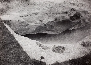 Rock recessed in grass