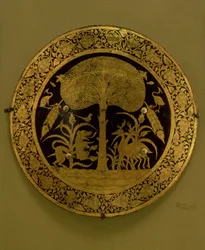 Plate with a Border of Stylised Flowers Surrounding a Scene of Exotic Animals under a Spreading Tree