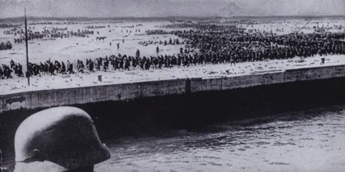 German soldier surveying Allied prisoners on the beach at Dunkirk, France, World War II, June 1940