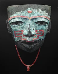 Funeral mask covered by turquoise and red shell mosaic. Artifact from Teotihuacan, Mexico City. Teotihuacan Civilization - Precolombian art: funeral mask of turquoise and pink stones dating from the civilization of Teotihuacan III (300-650 AD)