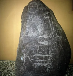 Civilization of the Camunni, Prehistory, rock art: grave rock, animals, arrow tips and spirals - Stele of Bagnolo type 2 in Valcamonica (Camonica Valley), Italy