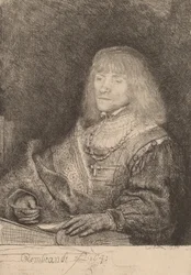 Man at a Desk Wearing a Cross and Chain