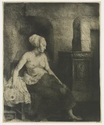 Woman sitting half dressed beside a stove