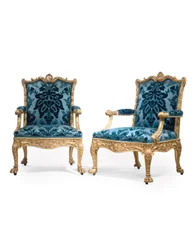 A pair of George III giltwood armchairs
