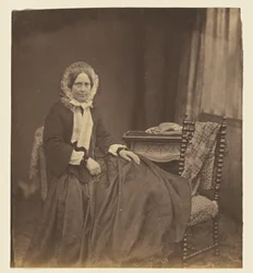 [Portrait of a woman, wearing a bonnet, seated]